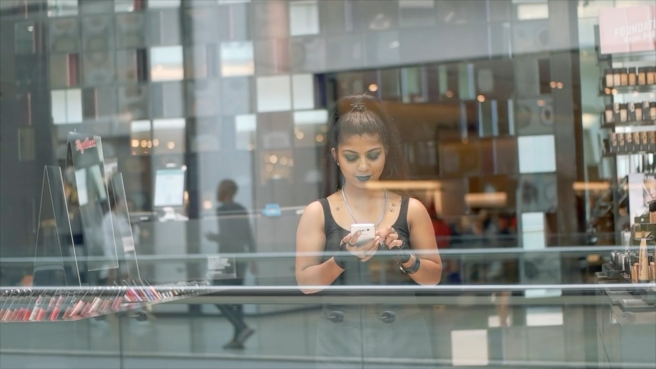 Women using roubler app through window