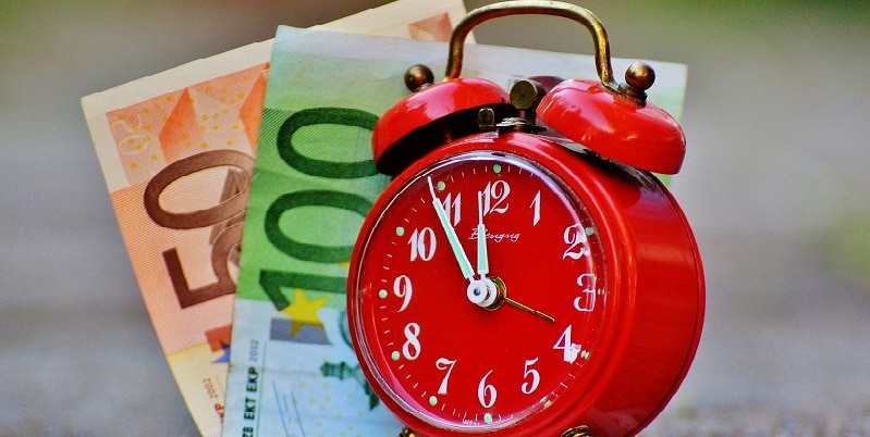 Clock and money denoting time theft
